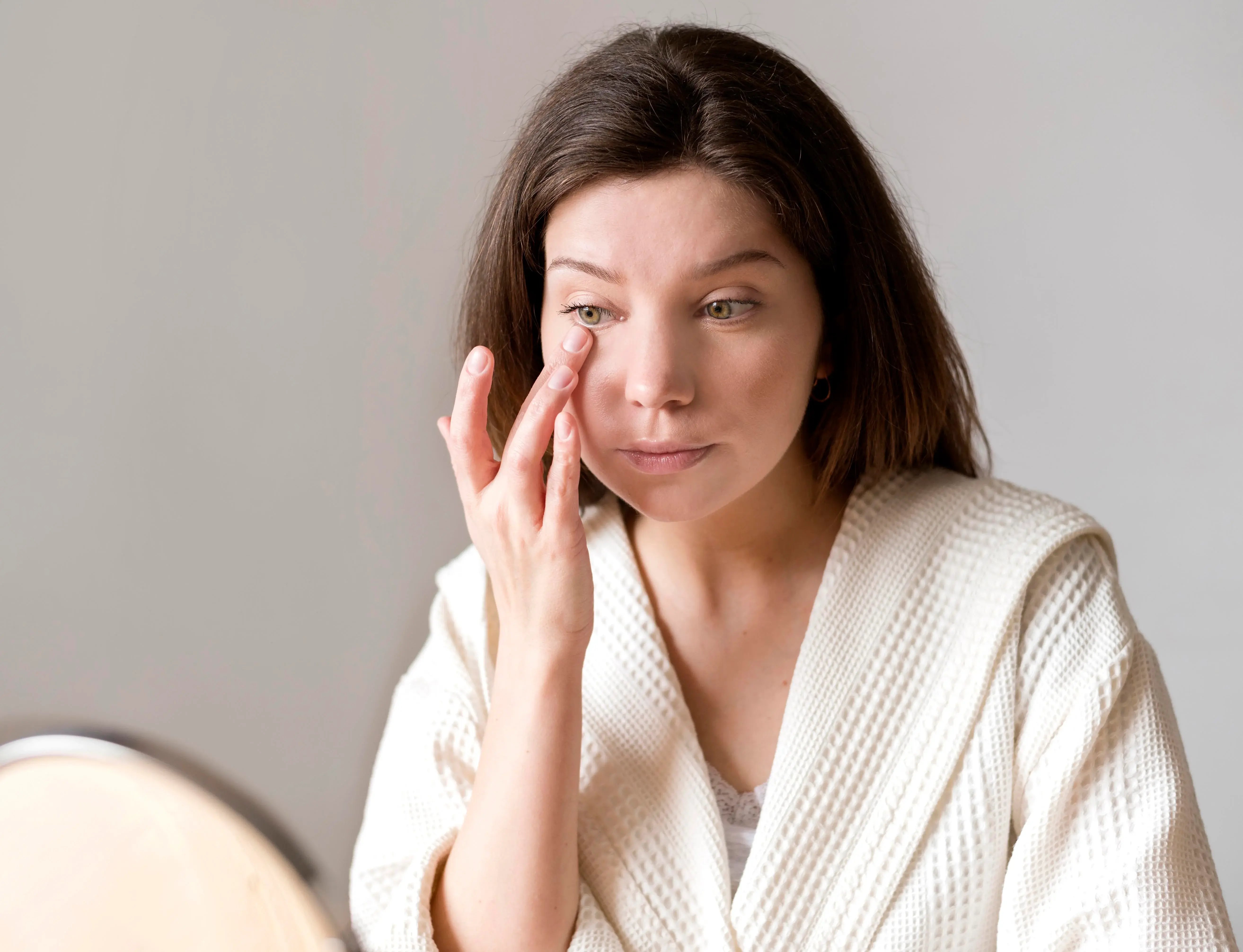 women analyzing her undereyes